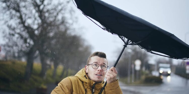 man with umbrella in wind and rain 2022 02 17 23 14 31 utc