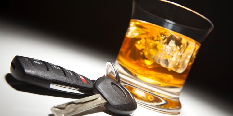 Alcoholic Drink and Car Keys Under Spot Light.